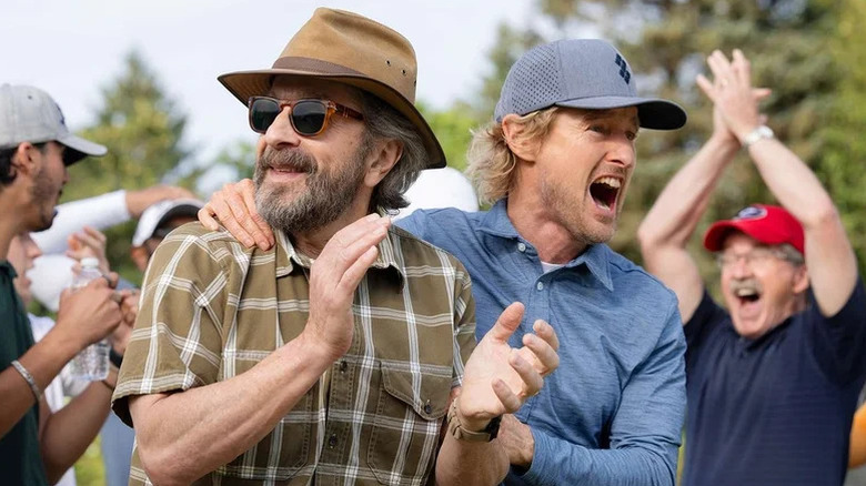 Pryce and Mitts cheering on a golf course on Stick