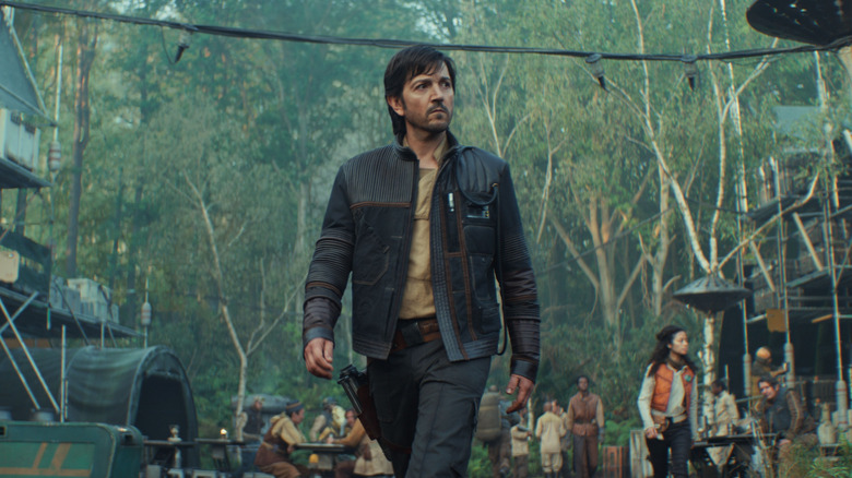 Cassian Andor walking through a village on Andor