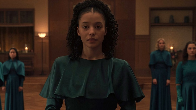 Agnes standing in front of other Green Girls in The Testaments