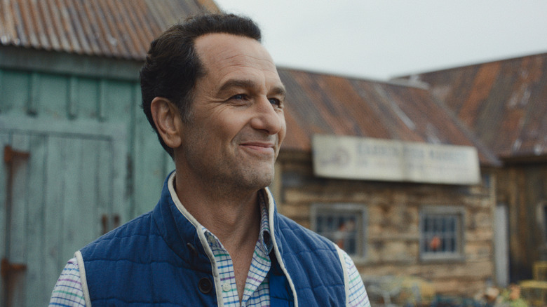 Tom smiling and looking into the distance in Widow's Bay