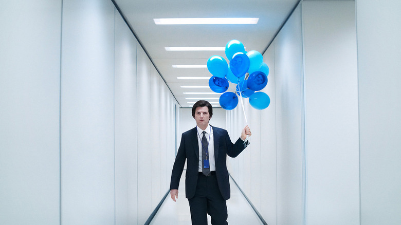 Mark S. holding balloons in the severed hallway on Severance