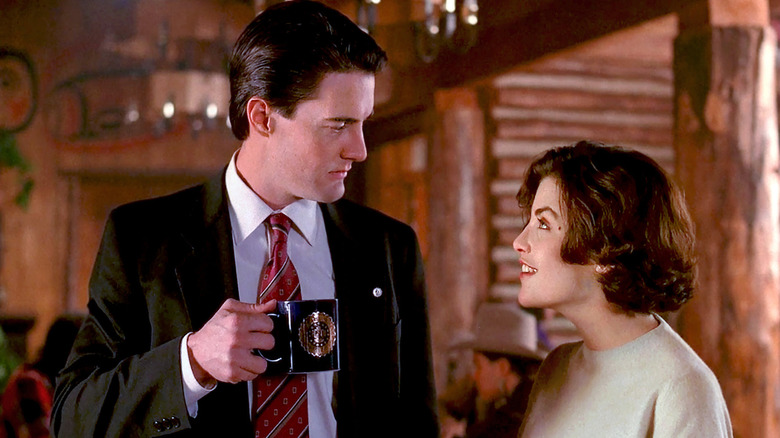 Dale Cooper drinking coffee talking to Audrey in Twin Peaks