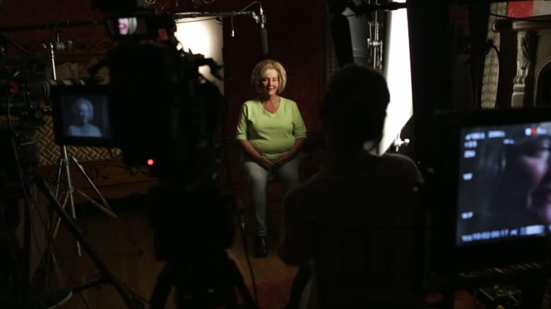 Sheila Janutolo surrounded by cameras and crew for the docuseries "Evil Lives Here" (2016-present)