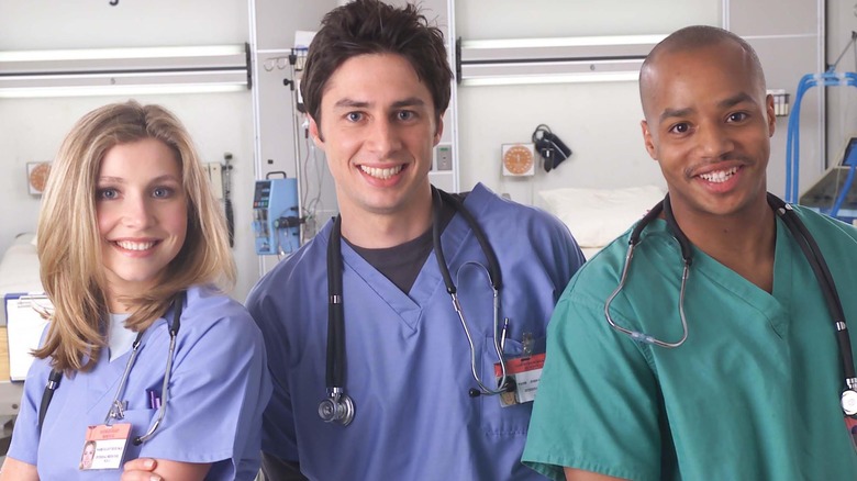 Elliot, J.D., and Turk smiling on Scrubs (2001 - 2010)