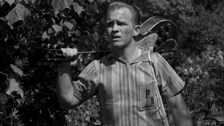 Floyd Burney holding his guitar on The Twilight Zone