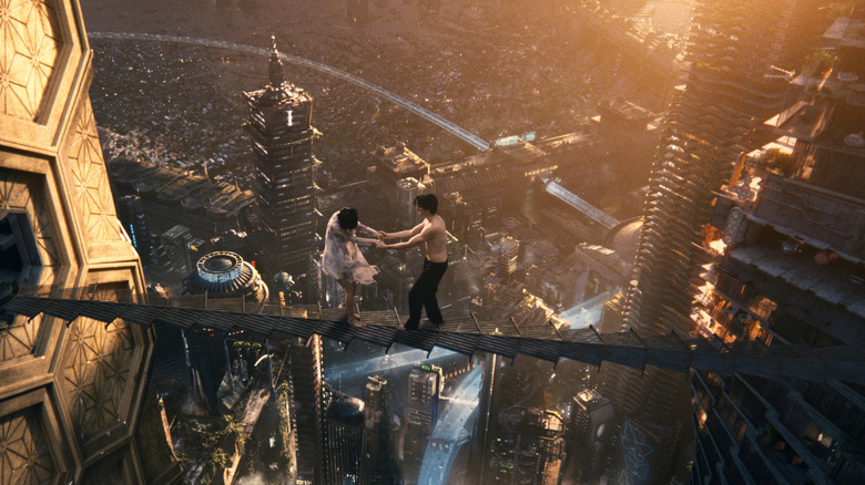 Sonmi-451 and Hae-Joo walk on a bridge between skyscrapers in "Cloud Atlas" (2012)