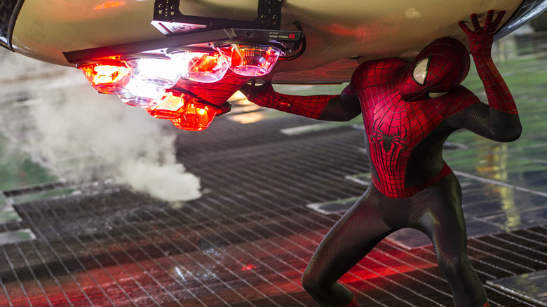 Spider-Man clutching a cop car in The Amazing Spider-Man 2 (2014)