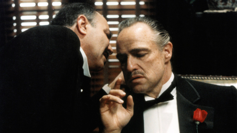 Vito Corleone being whispered something in The Godfather (1972)