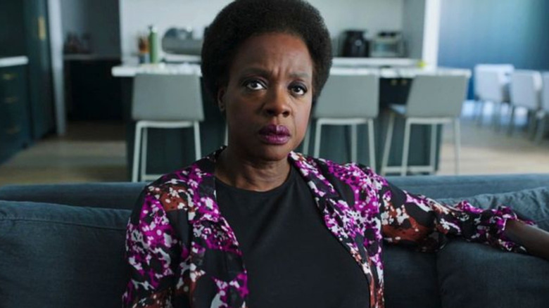 Amanda Waller watching a devastating news report in Peacemaker (2022)