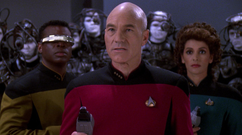Picard, Geordi, and Troi surrounded by Borg in "Star Trek: The Next Generation"