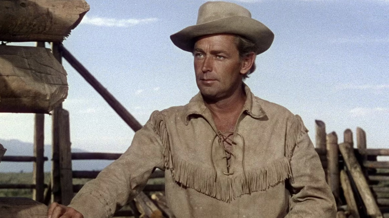 Shane puts his hand on a fence in Shane (1953)