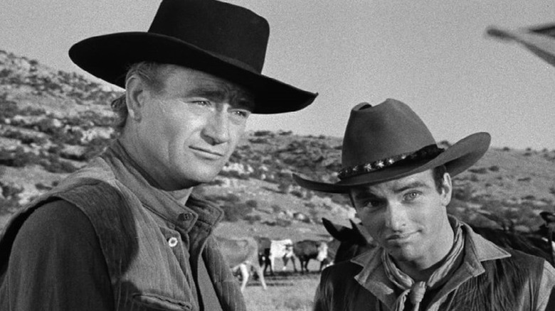 Thomas (John Wayne) and Matt (Montgomery Clift) standing next to each other in "Red River."