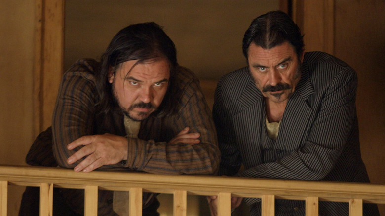 Al Swearengen and Dan Dority stare downward in 