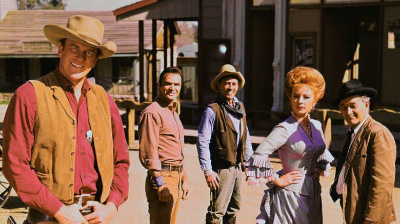 Marshal Matt Dillon, Quint Asper, Deputy Festus Haggen, Kitty Russell and Galen "Doc" Adams on the street of Dodge City on Gunsmoke (1955-1975)