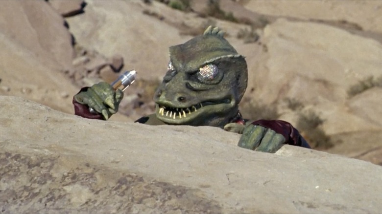 The Gorn captain looks super sneaky crouched behind a stone ridge on Star Trek: The Original Series