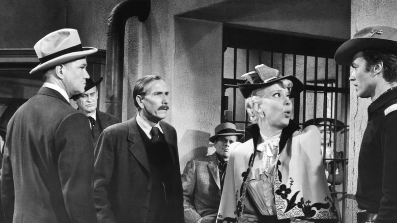 Lieutenant Jack Rice talking to three other First Traveling Saleslady characters (1956)