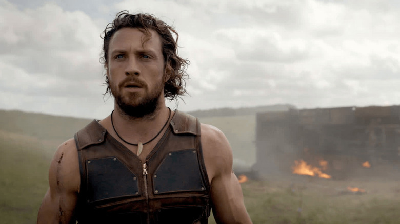 Kraven standing in the wreckage of a battle in Kraven the Hunter (2024)