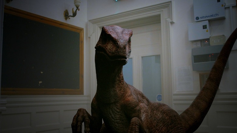 A raptor lurking in a hotel hallway in Dinosaur Hotel (2021)