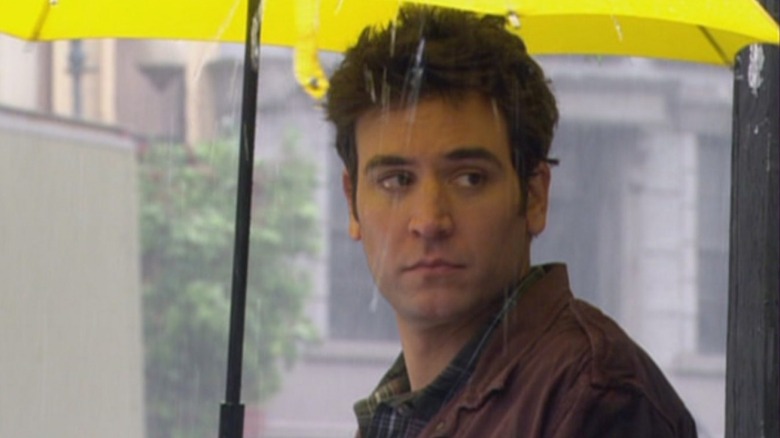 Ted looking over his shoulder under the yellow umbrella in How I Met Your Mother