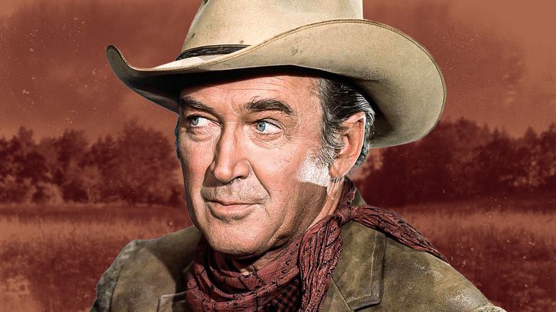 James Stewart in a cowboy outfit in front of brown plains background