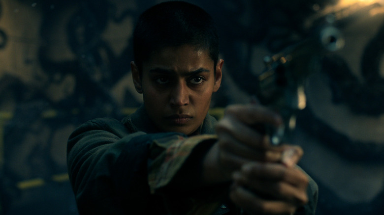 Kali points a gun in "Stranger Things"