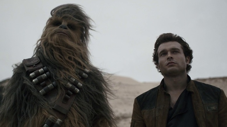 Chewbacca and Han Solo watching a ship take off in Solo: A Star Wars Story (2018)