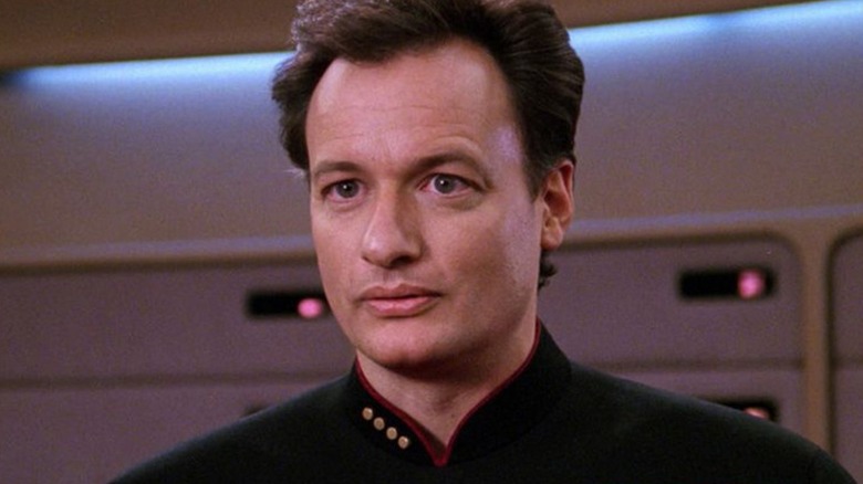 Q in a Star Trek uniform in Star Trek: The Next Generation (1989)