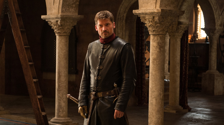 Jaime standing between columns with his sword on Game of Thrones