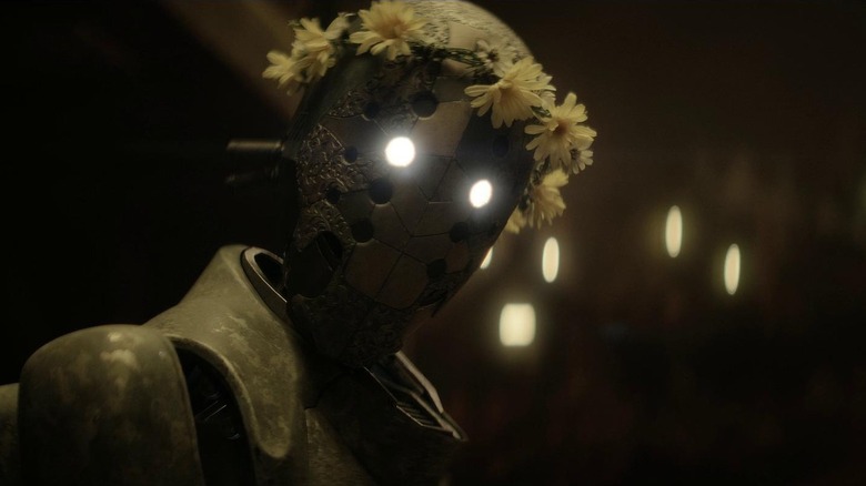 Jimmy the robot looking over in "Rebel Moon" (2023)