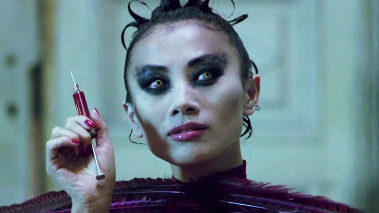 Lucy Westenra holds a blood-filled syringe