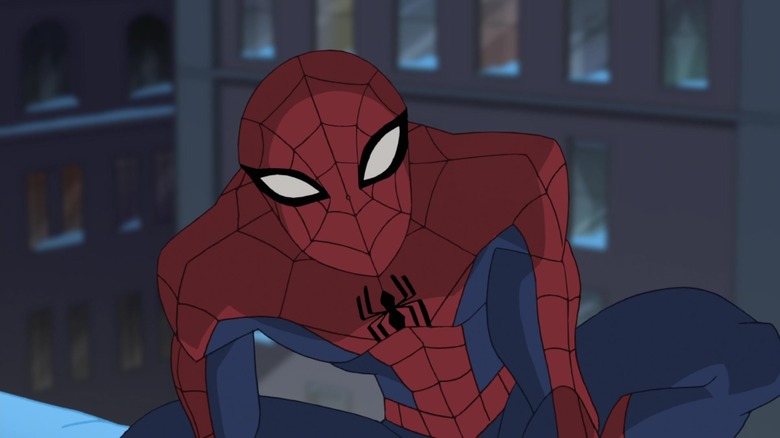 Spider-Man squints crouching on rooftop