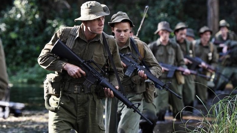 American Recon patrol walking across Vietnamese creek