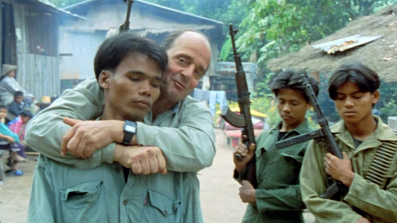 Dieter Dengler hugging Vietnamese civilian from behind
