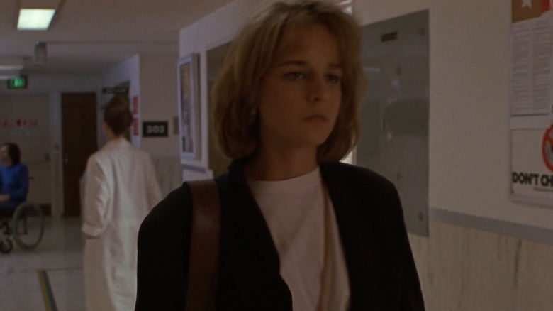 Helen Hunt walks down a hospital hallway