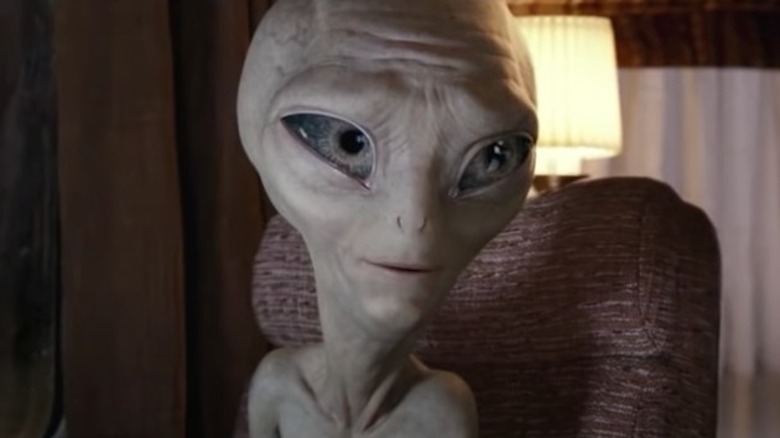 Alien Paul smiling indoors