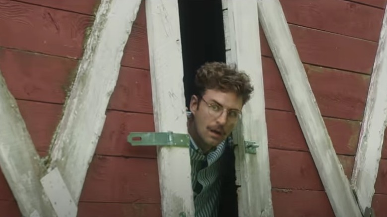 Jackie Wyndam peeking from barn