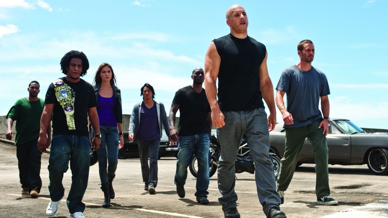 Dominic Toretto and his crew walk away from cars