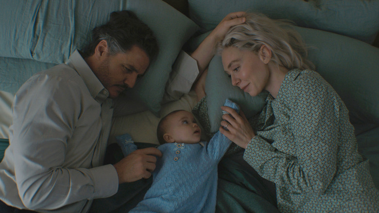Reed Richards and Sue Storm cuddle with Franklin Richards in "The Fantastic Four: First Steps" (2025)