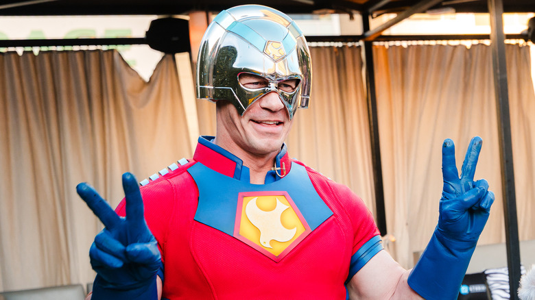 John Cena in "Peacemaker" costume giving peace signs