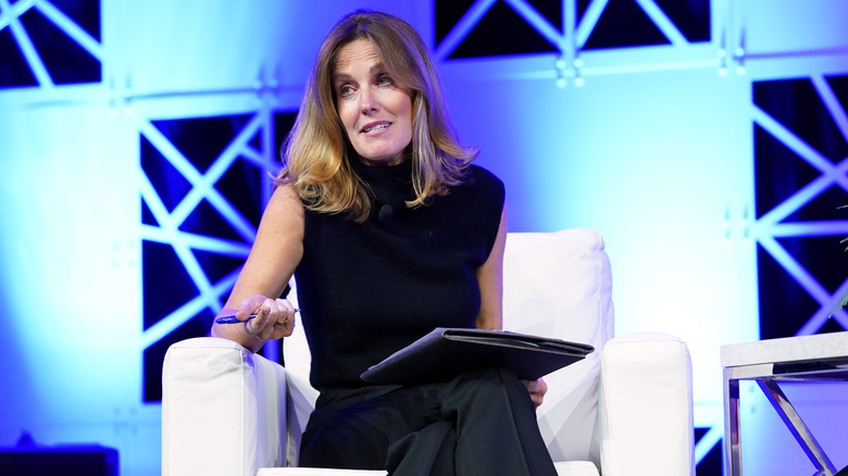 Sharyn Alfonsi sitting in a chair onstage speaking