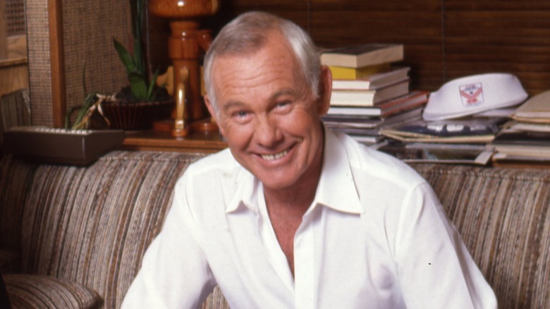 Johnny Carson poses on couch