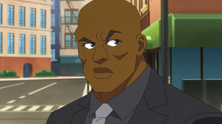 Titan standing outside in a suit in 