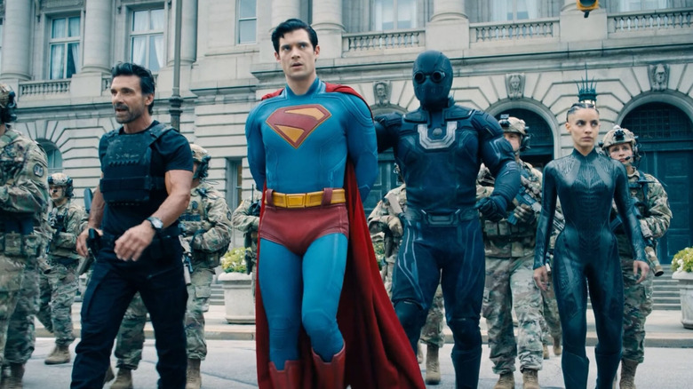Superman getting escorted to jail by Rick Flagg Sr., Ultraman, and The Engineer in Superman (2025)