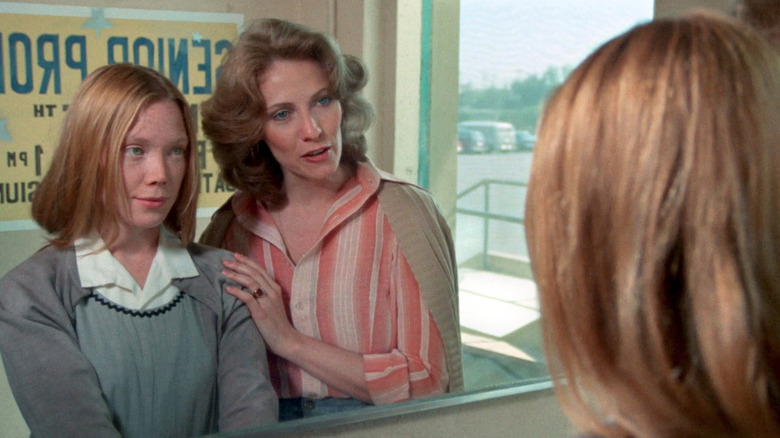 Carrie looking at Miss Collins in the mirror in Carrie (1976)