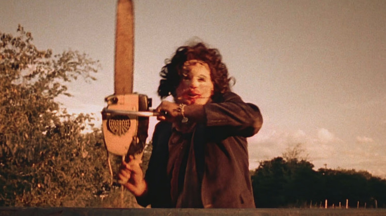 Leatherface in The Texas Chain Saw Massacre wielding his signature weapon