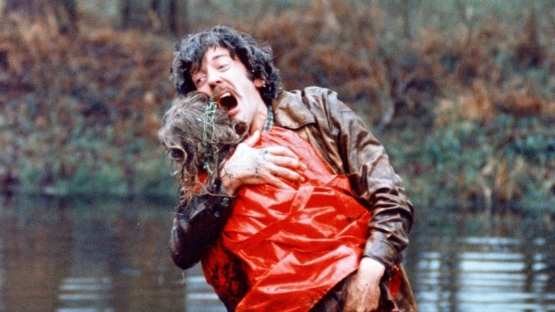 John holding a girl in a lake in "Don't Look Now."