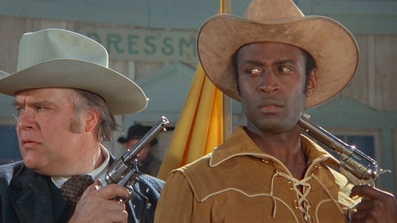 Bart and a man holding guns to his head in "Blazing Saddles"