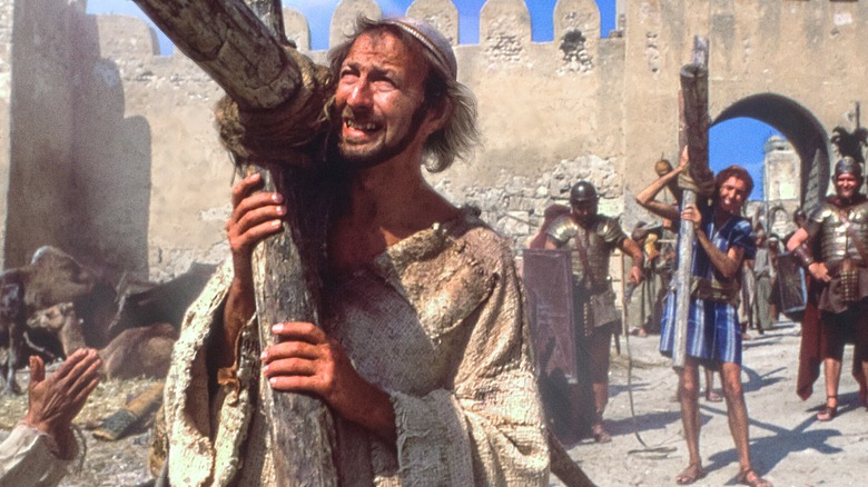 Brian carrying a cross with others in "Monty Python's Life of Brian"