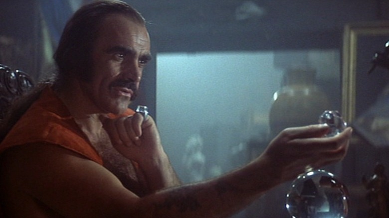 Zed observing a piece of crystal in Zardoz