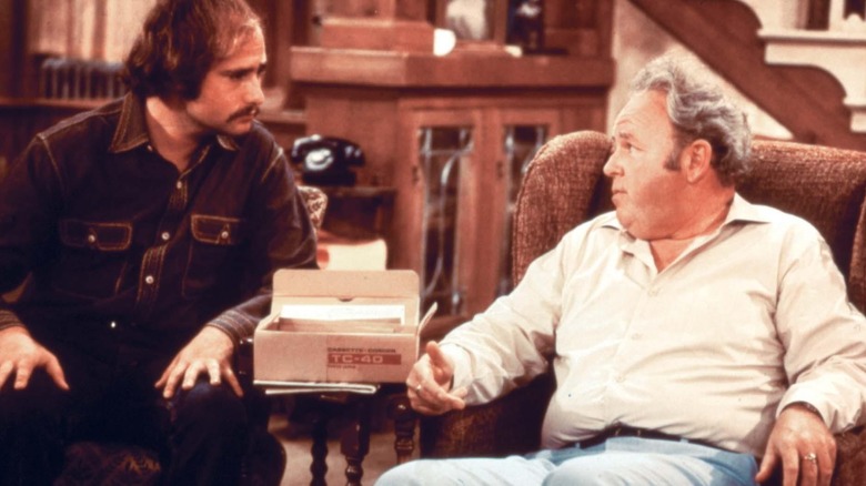 Meathead and Archie sitting in chairs talking in All in the Family (1971)
